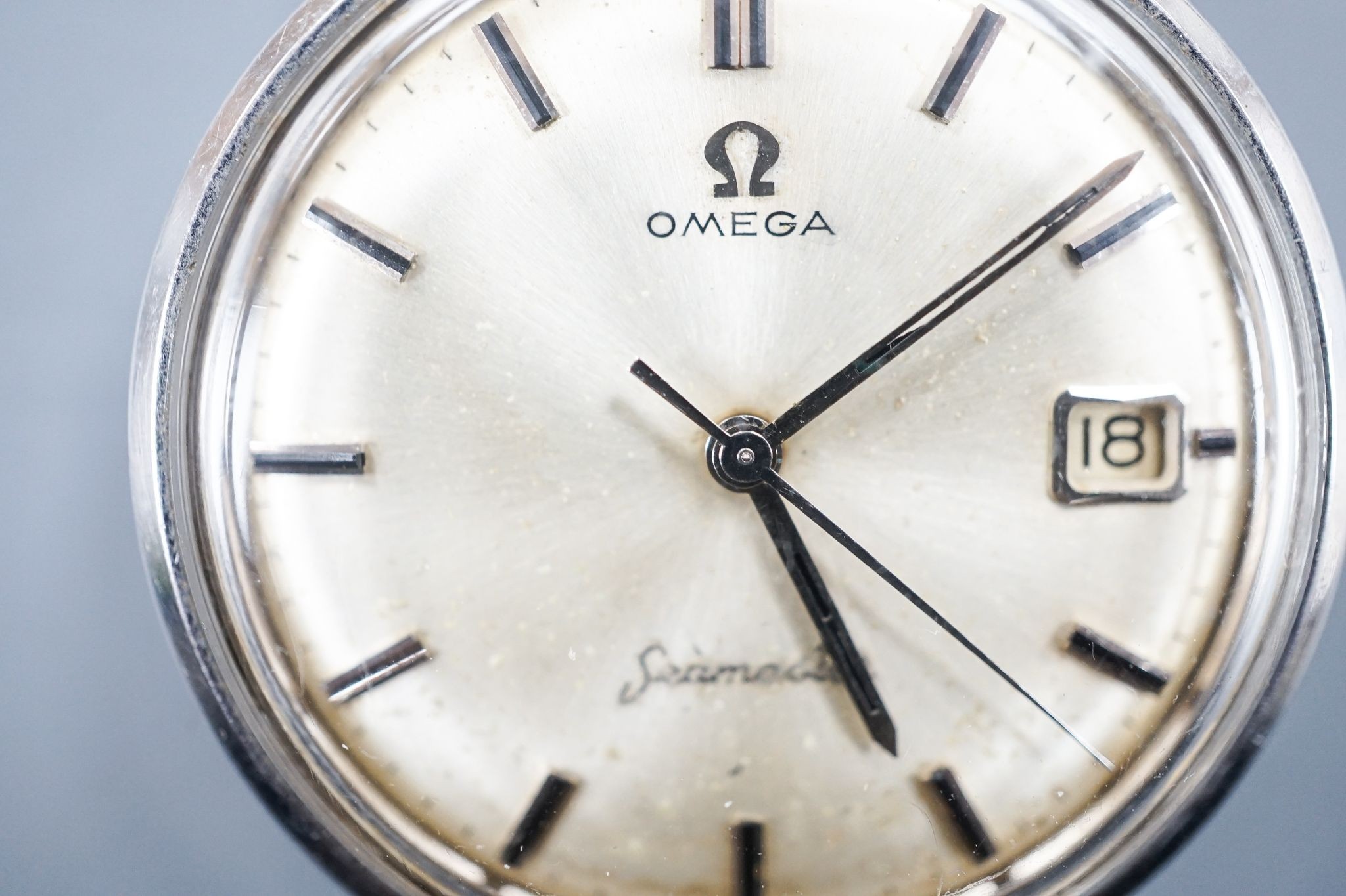 A gentleman's stainless steel Omega Seamaster manual wind wrist watch, on associated black leather strap, case diameter 35mm.